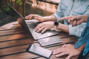 people laptop discussing home buying